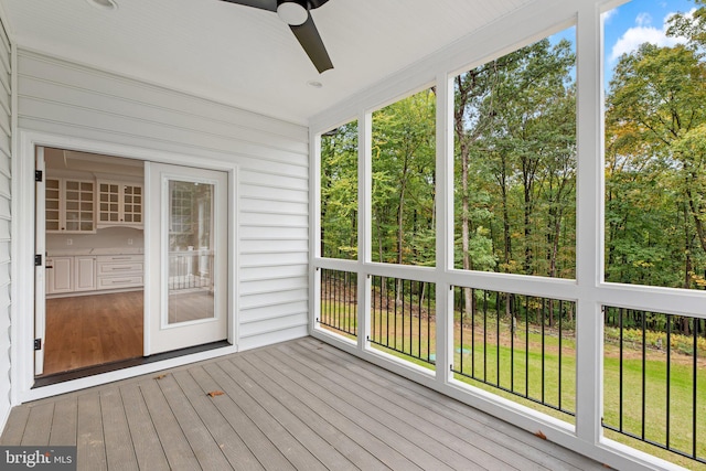 unfurnished sunroom featuring plenty of natural light and ceiling fan