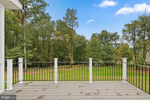 wooden terrace featuring a lawn