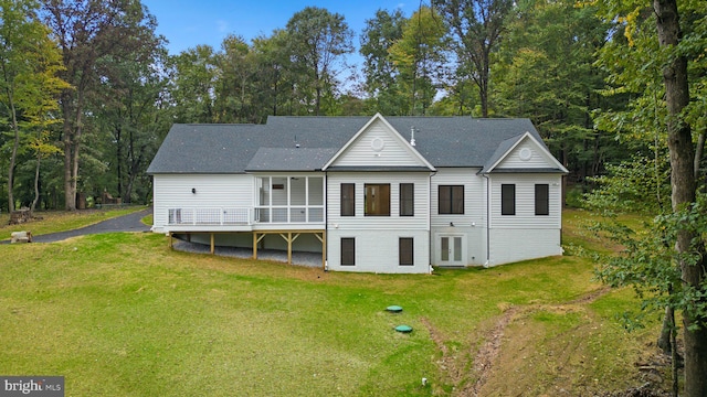 back of house with a lawn