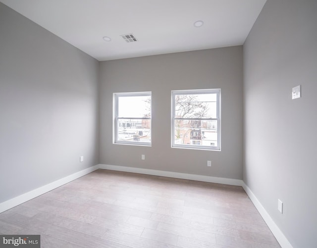 unfurnished room with light hardwood / wood-style floors