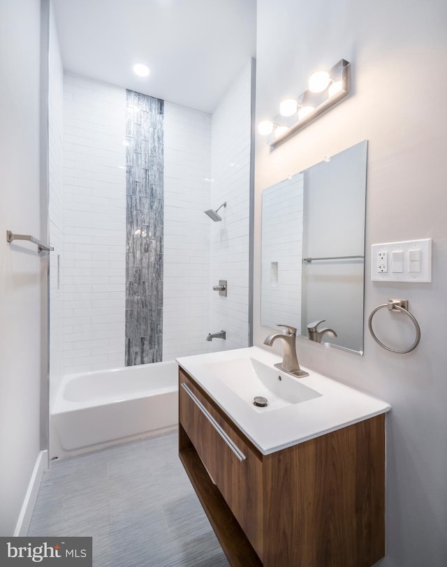 bathroom featuring vanity and tiled shower / bath