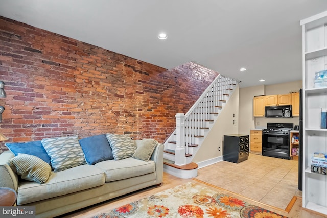 tiled living room featuring brick wall