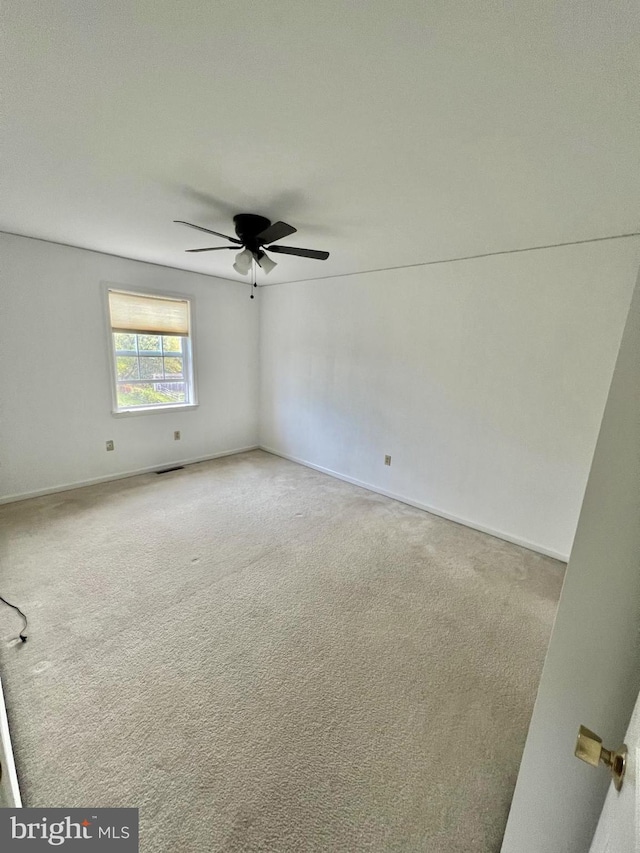 carpeted empty room with ceiling fan