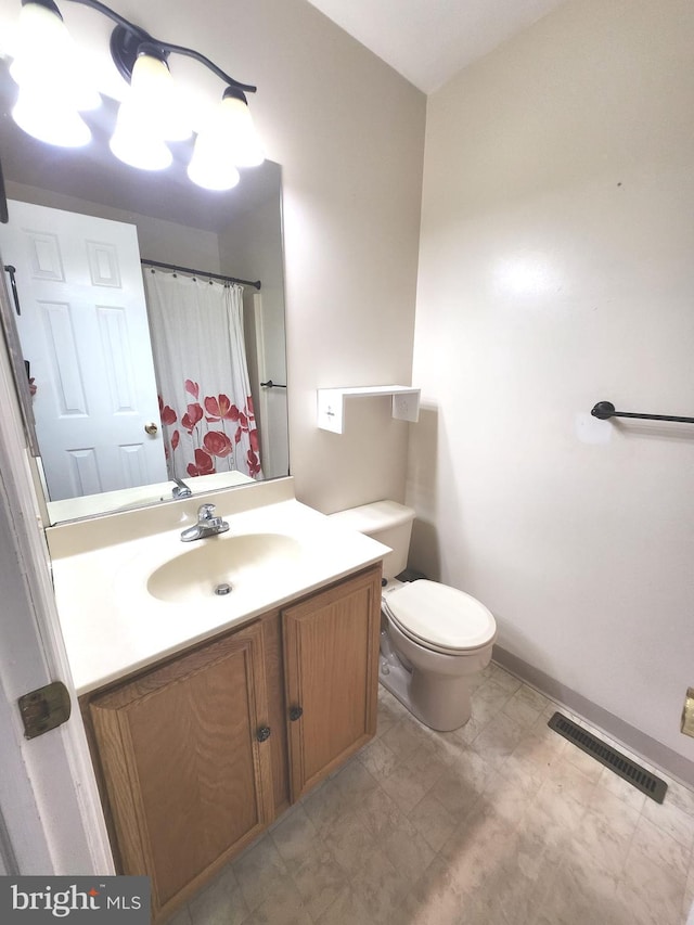 bathroom with toilet and vanity