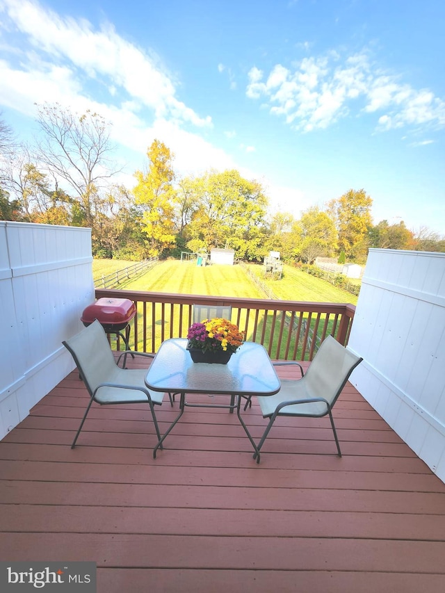 wooden deck with a yard