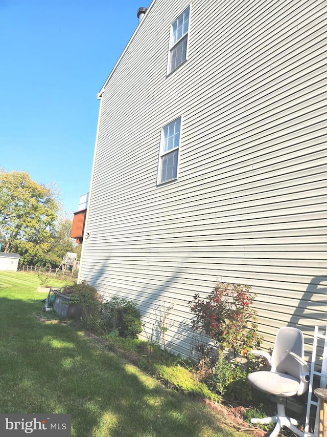 view of side of property with a lawn