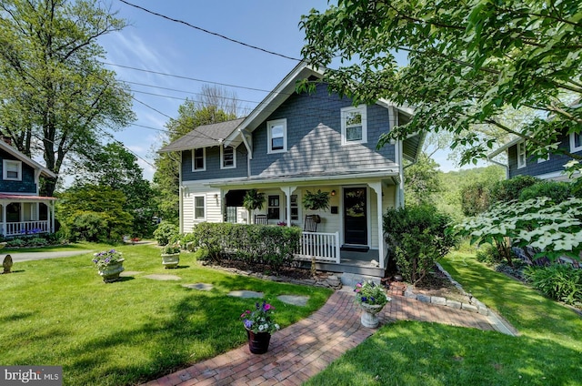 view of front facade with a front lawn and a porch