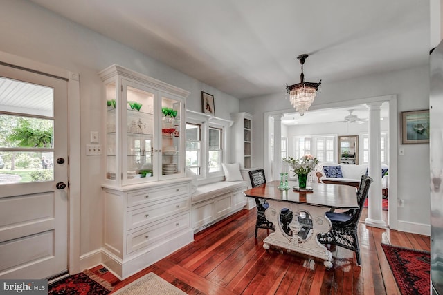 dining room featuring dark hardwood / wood-style floors, plenty of natural light, and ceiling fan with notable chandelier