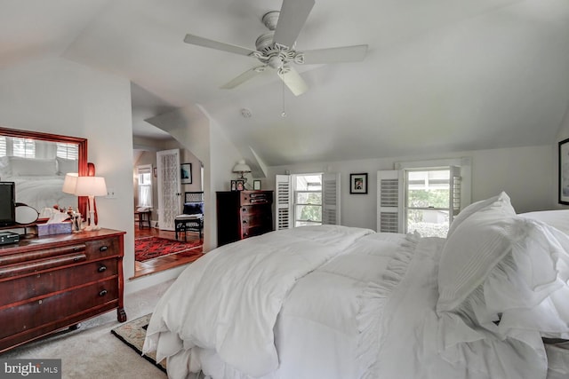 carpeted bedroom with ceiling fan and lofted ceiling