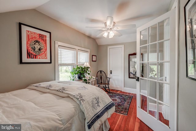 bedroom featuring hardwood / wood-style floors, vaulted ceiling, and ceiling fan