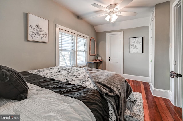 bedroom with ceiling fan, dark hardwood / wood-style flooring, and lofted ceiling