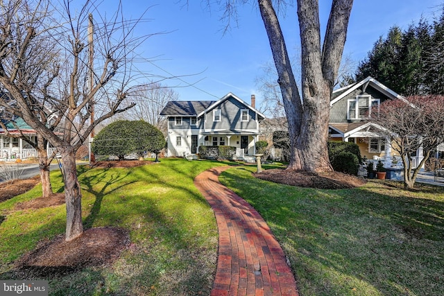 view of front of house with a front yard and a porch