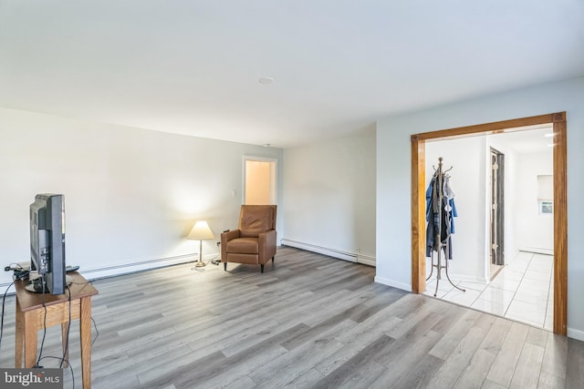 sitting room featuring light wood-type flooring and baseboard heating