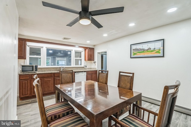 dining room featuring ceiling fan, sink, and a baseboard radiator