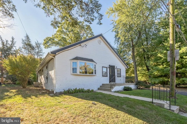 bungalow-style home with a front lawn