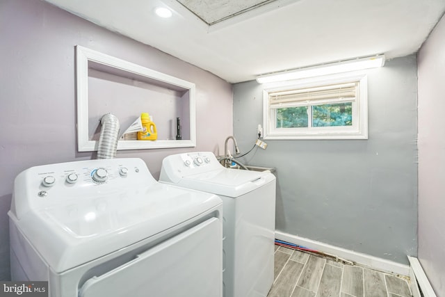 laundry area featuring independent washer and dryer and a baseboard heating unit