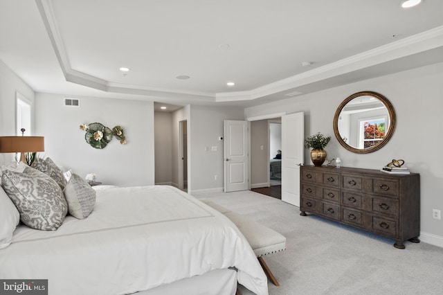 bedroom featuring a tray ceiling, crown molding, and light colored carpet