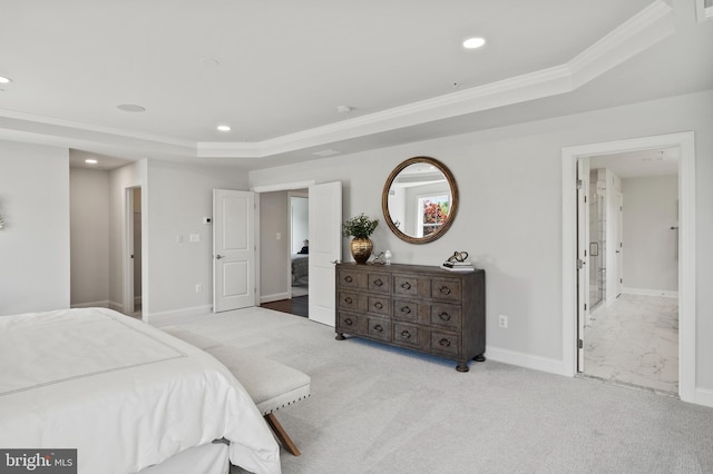 bedroom featuring ornamental molding, light carpet, and a tray ceiling