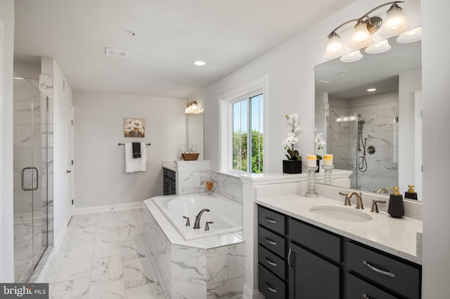 bathroom with vanity and independent shower and bath