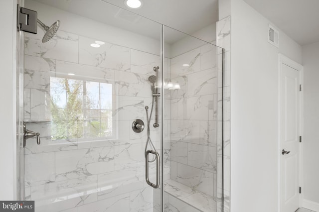 bathroom with a shower with shower door