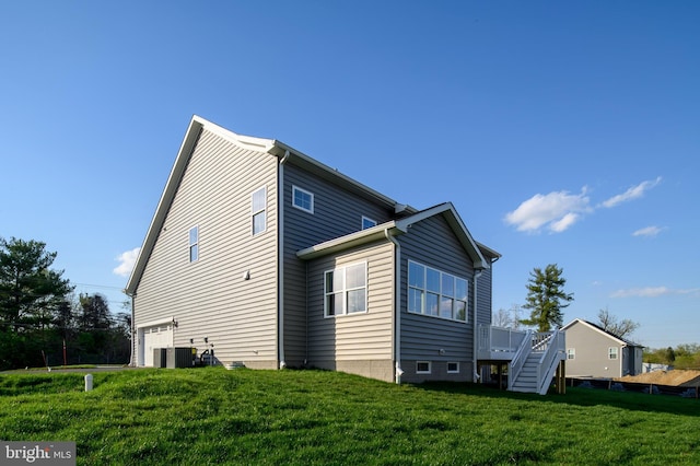 view of property exterior with a yard, a garage, a deck, and central air condition unit