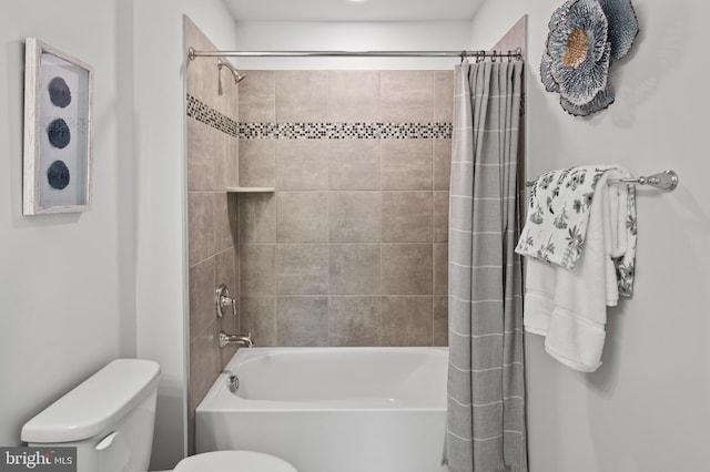 bathroom with shower / bath combo and toilet