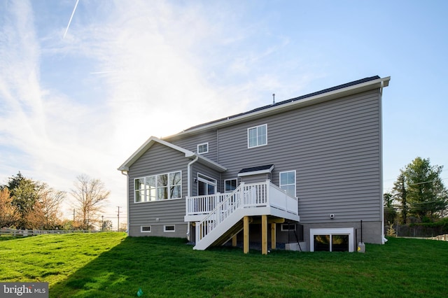 rear view of property featuring a yard and a deck