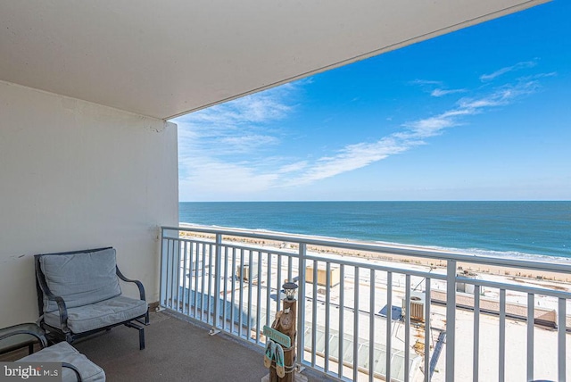 balcony with a beach view and a water view