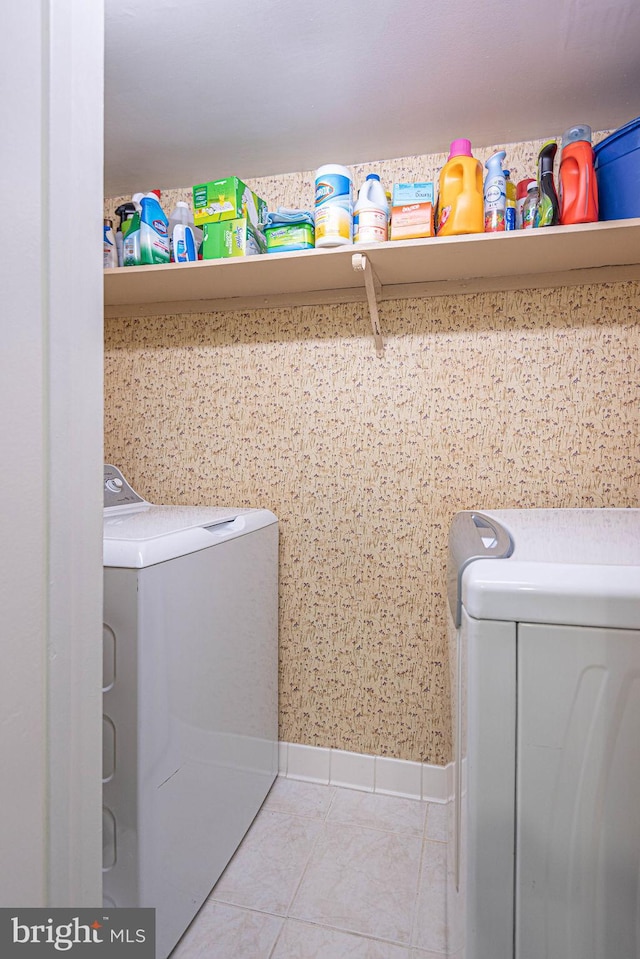 laundry area featuring light tile patterned floors and washer and dryer