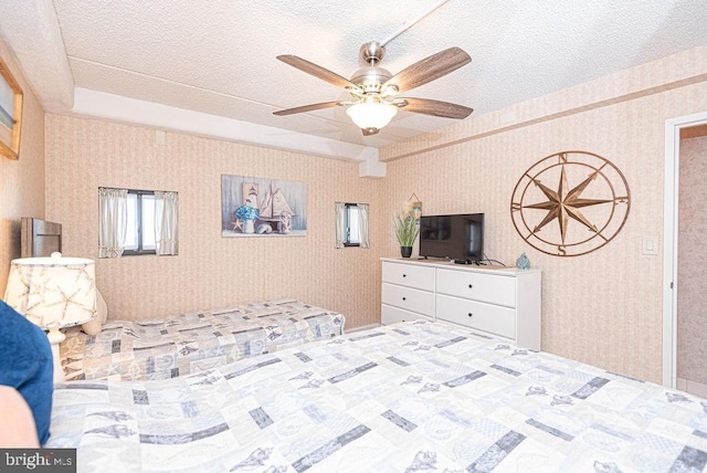 bedroom with a textured ceiling and ceiling fan