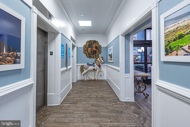 corridor featuring crown molding and dark wood-type flooring