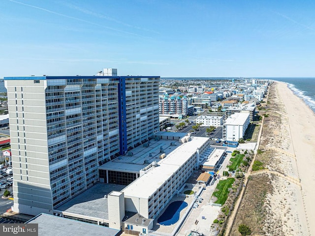 bird's eye view with a water view and a beach view