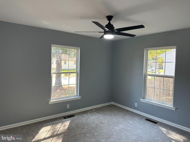 empty room with ceiling fan and carpet