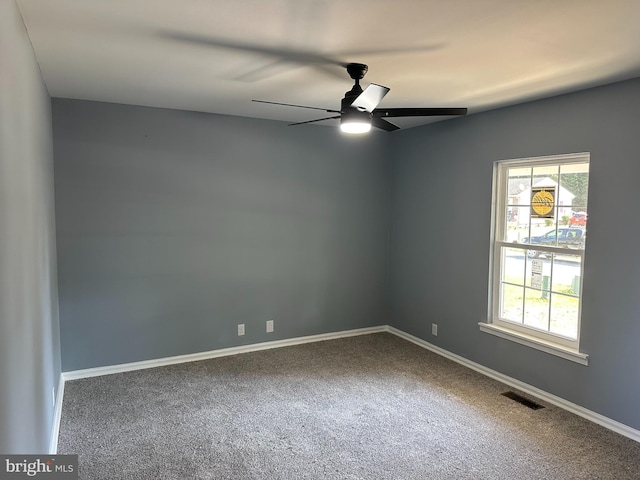 spare room with carpet floors and ceiling fan