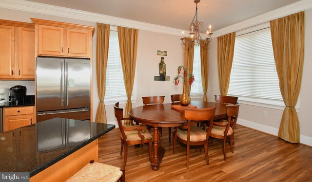 9 134th St Unit 9A, Ocean City, MD 21842 - dining room featuring a chandelier, light wood-style flooring, ornamental molding, baseboards, and plenty of natural light