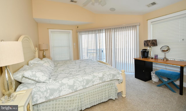 carpeted bedroom featuring vaulted ceiling and visible vents