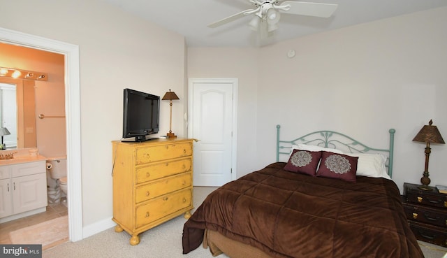 bedroom featuring light colored carpet and connected bathroom