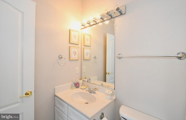 half bathroom with toilet and vanity