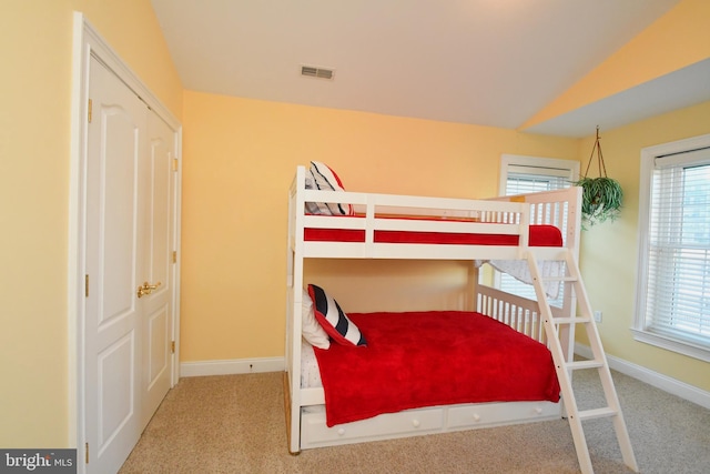 carpeted bedroom featuring visible vents and baseboards