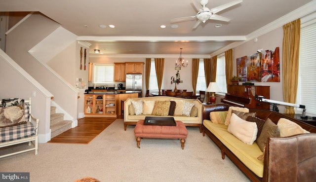 living area with plenty of natural light, recessed lighting, stairs, and ornamental molding