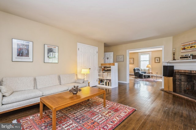 living room with a fireplace and dark hardwood / wood-style flooring