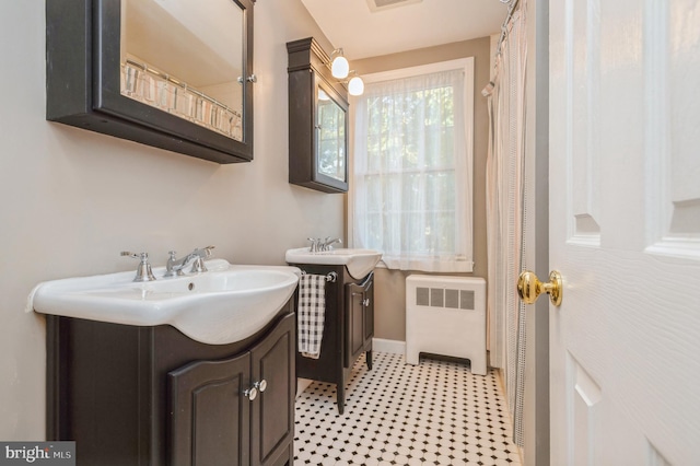 bathroom featuring vanity and radiator heating unit