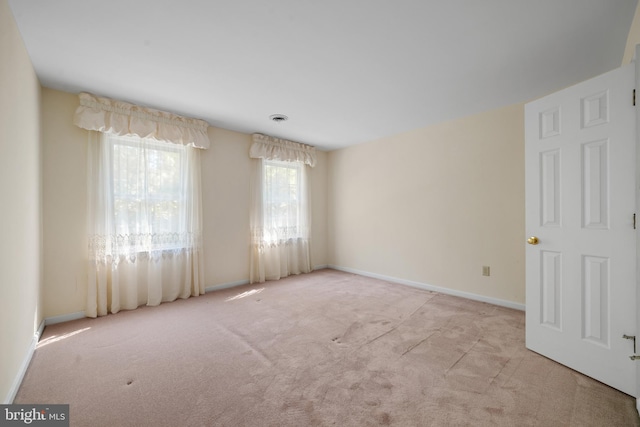 spare room with light colored carpet