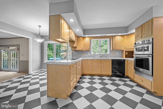 kitchen with light brown cabinetry, decorative light fixtures, sink, kitchen peninsula, and black appliances