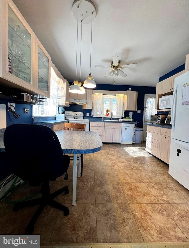 kitchen with white appliances, ceiling fan, sink, and hanging light fixtures