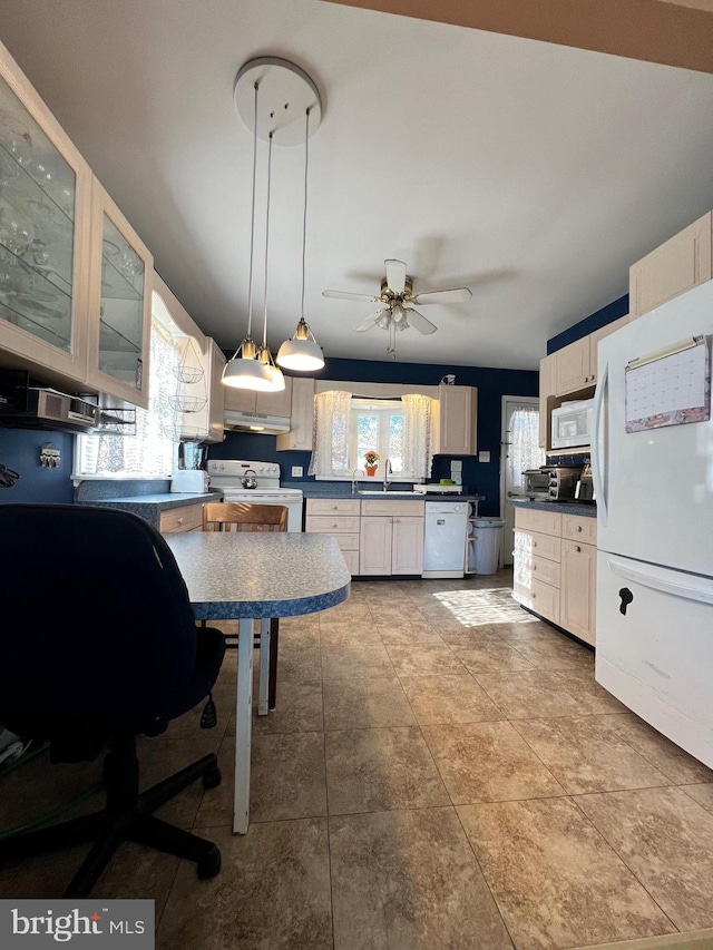 kitchen featuring white appliances, hanging light fixtures, ceiling fan, sink, and tile patterned flooring