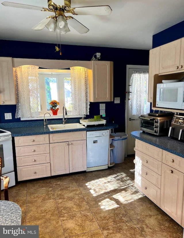 kitchen with white appliances, a healthy amount of sunlight, tasteful backsplash, and sink