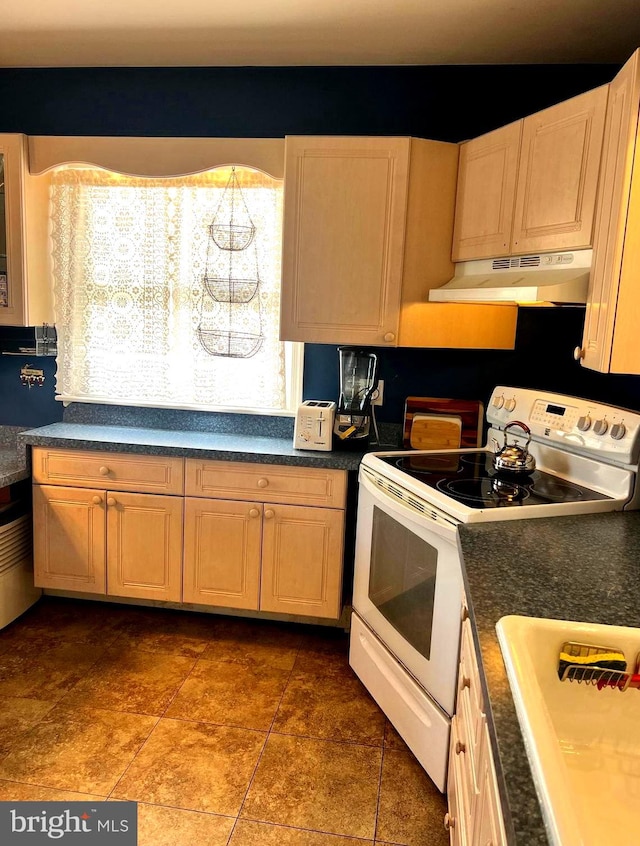 kitchen featuring sink, tile patterned floors, and white range with electric cooktop