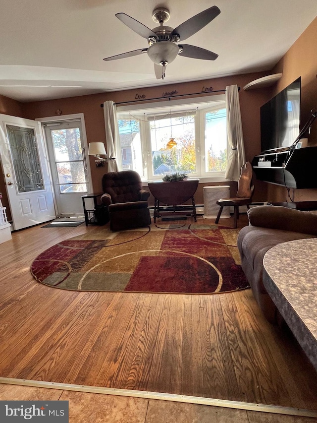 living room with ceiling fan and hardwood / wood-style floors