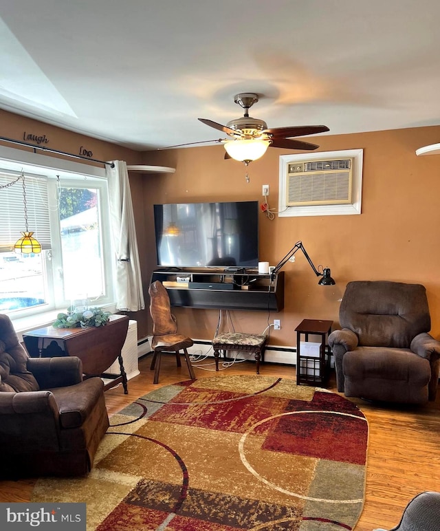 living room with an AC wall unit, hardwood / wood-style flooring, and ceiling fan